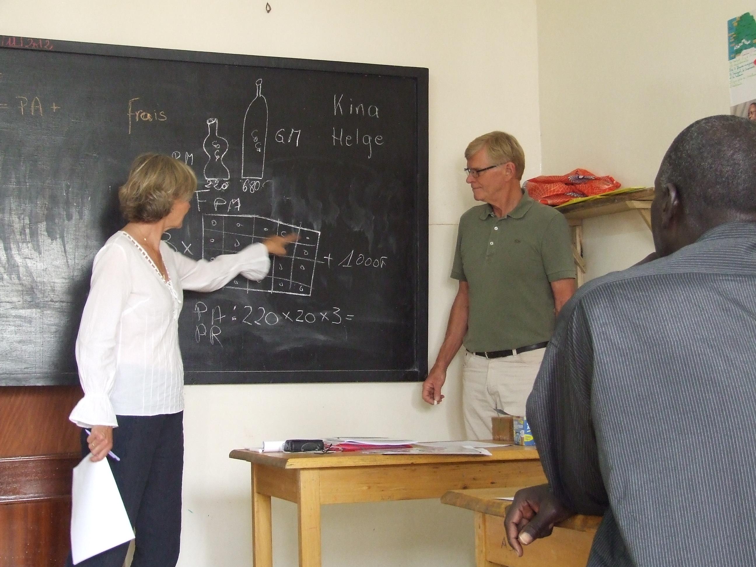 Students in Africa attend a maths class taught by older adults volunteering abroad on a Projects Abroad Micro-finance Project. 