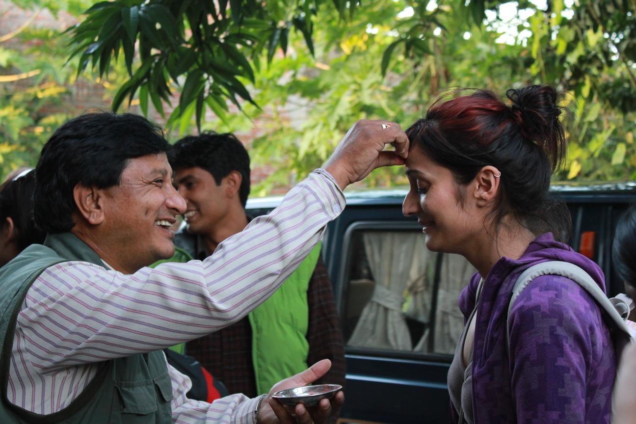 Projects Abroad volunteer get welcomed by her host family in Nepal.