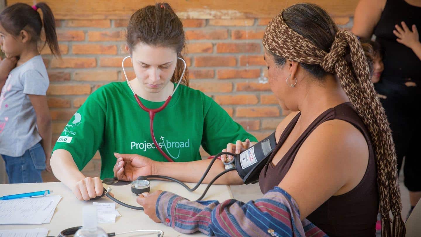 Projects Abroad volunteer measures the blood pressure of a local woman in Mexico