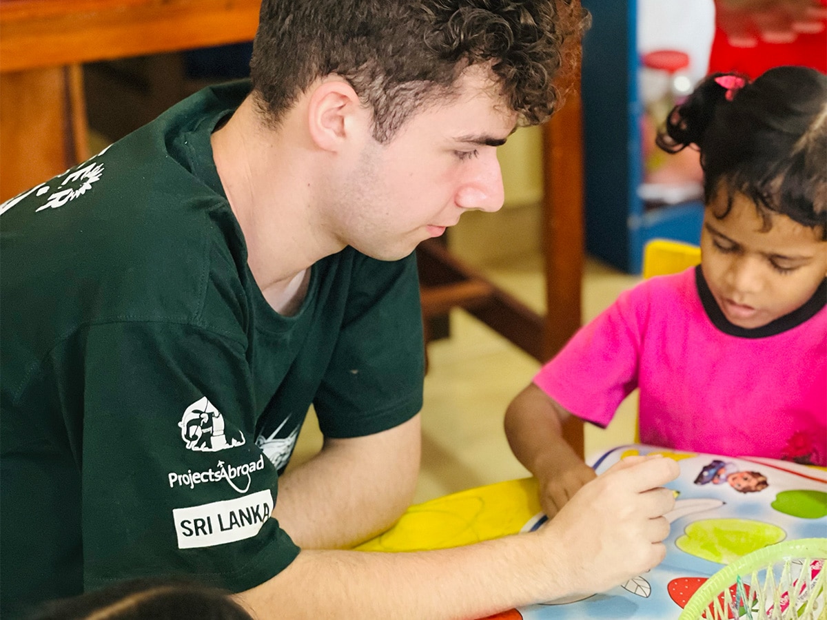 Volunteer Teaching Child Sri Lanka