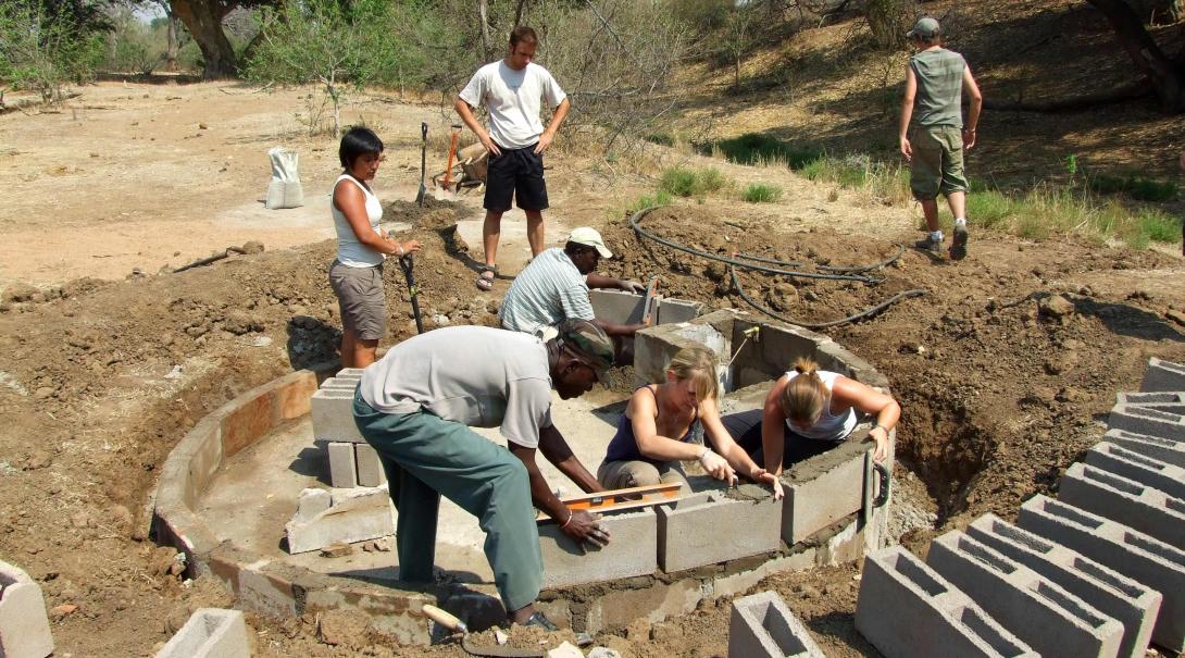 Teens building a waterhole in Botswana