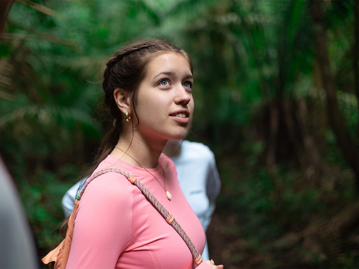 Peru girl looking up at trees
