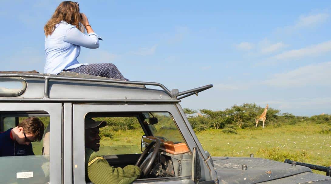 Conservation volunteers spotting giraffes in Kenya