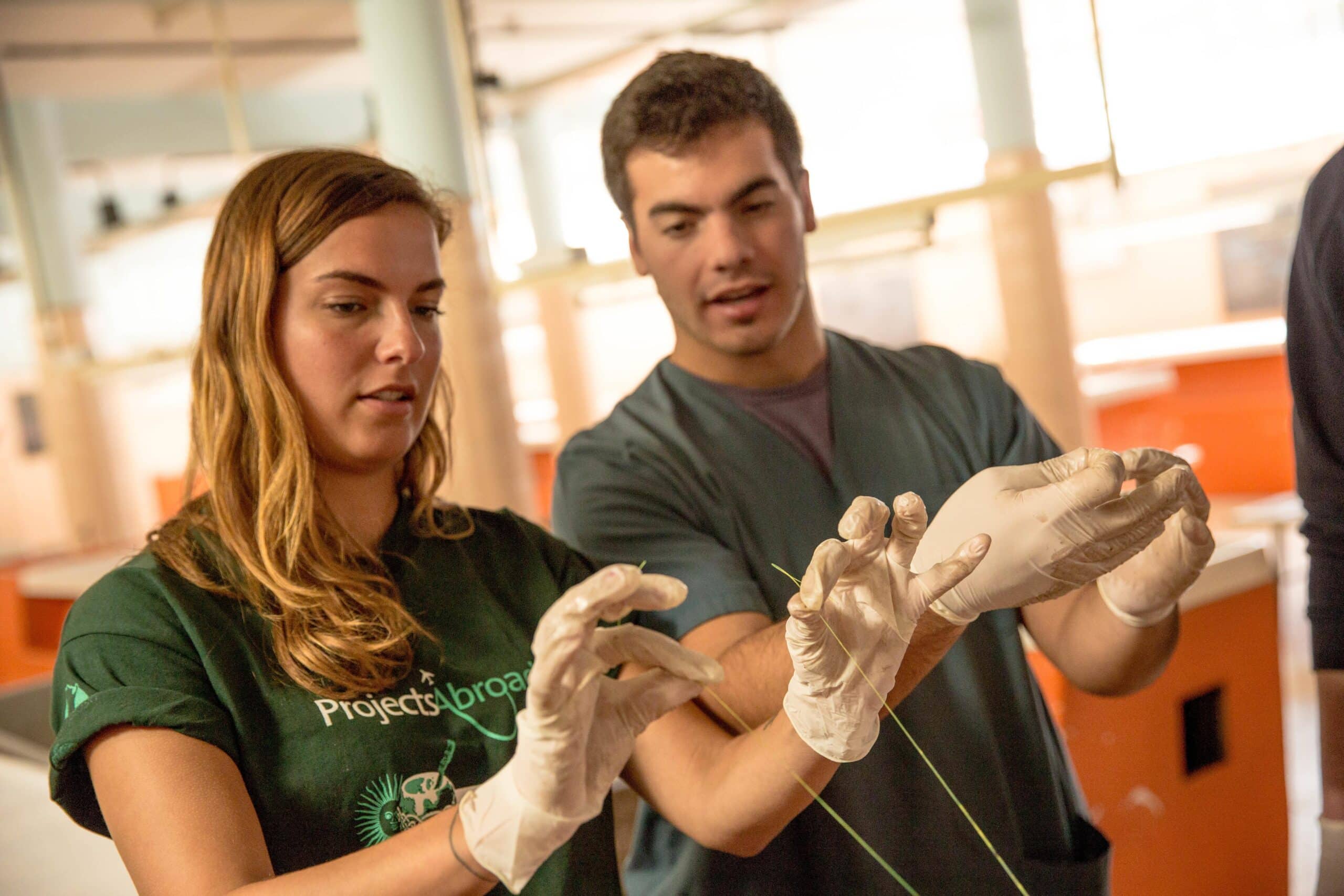 A Projects Abroad volunteer gains skills from volunteering abroad by learning from a local doctor.