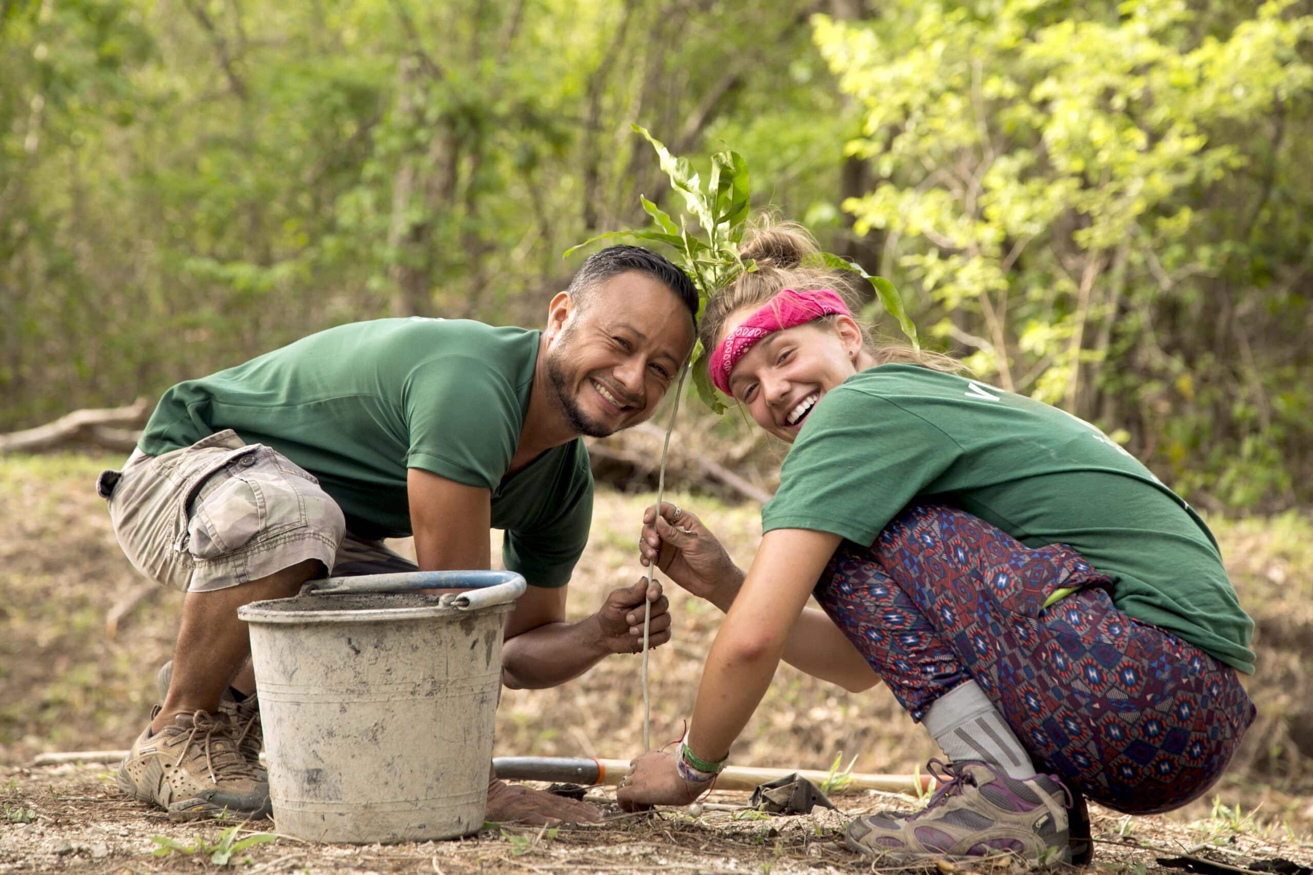 A Projects Abroad Conservation volunteer planting a tree on one of our best volunteer abroad programmes UK.