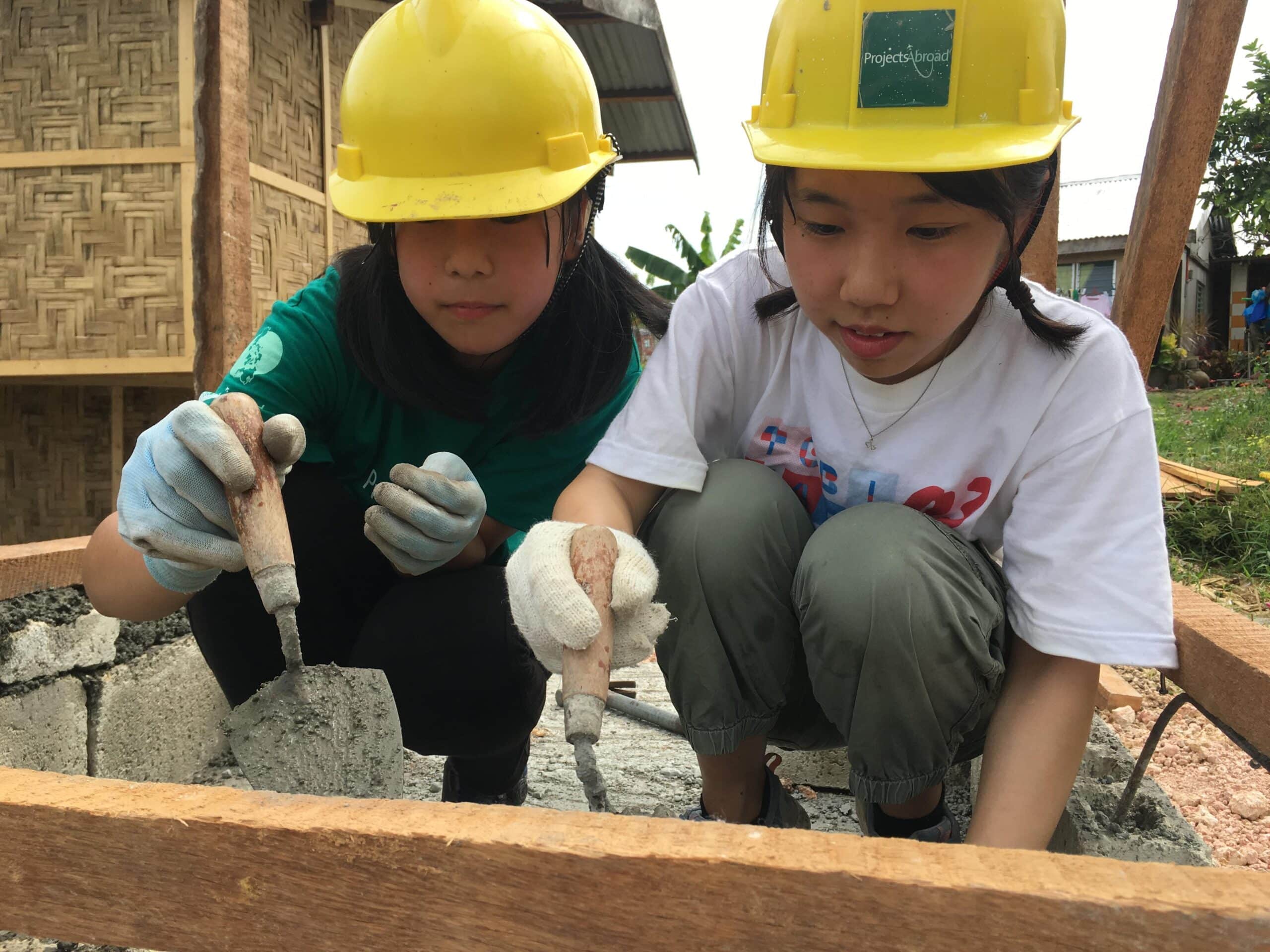 Two Projects Abroad volunteers building a house on one of our best volunteer abroad programmes.