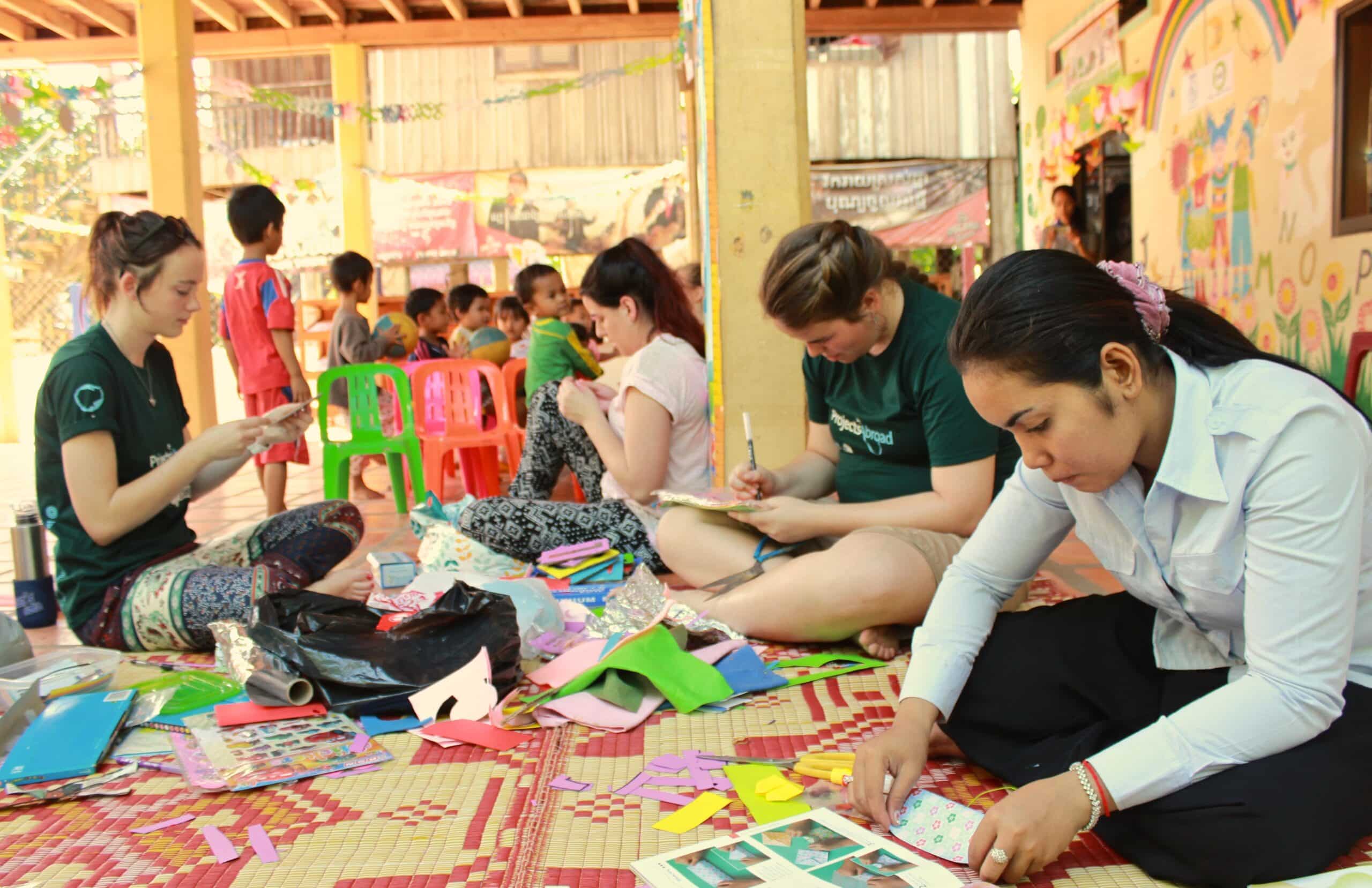 A group of High School Special volunteers is preparing an arts and crafts class for the local children during their care & community project in Cambodia.