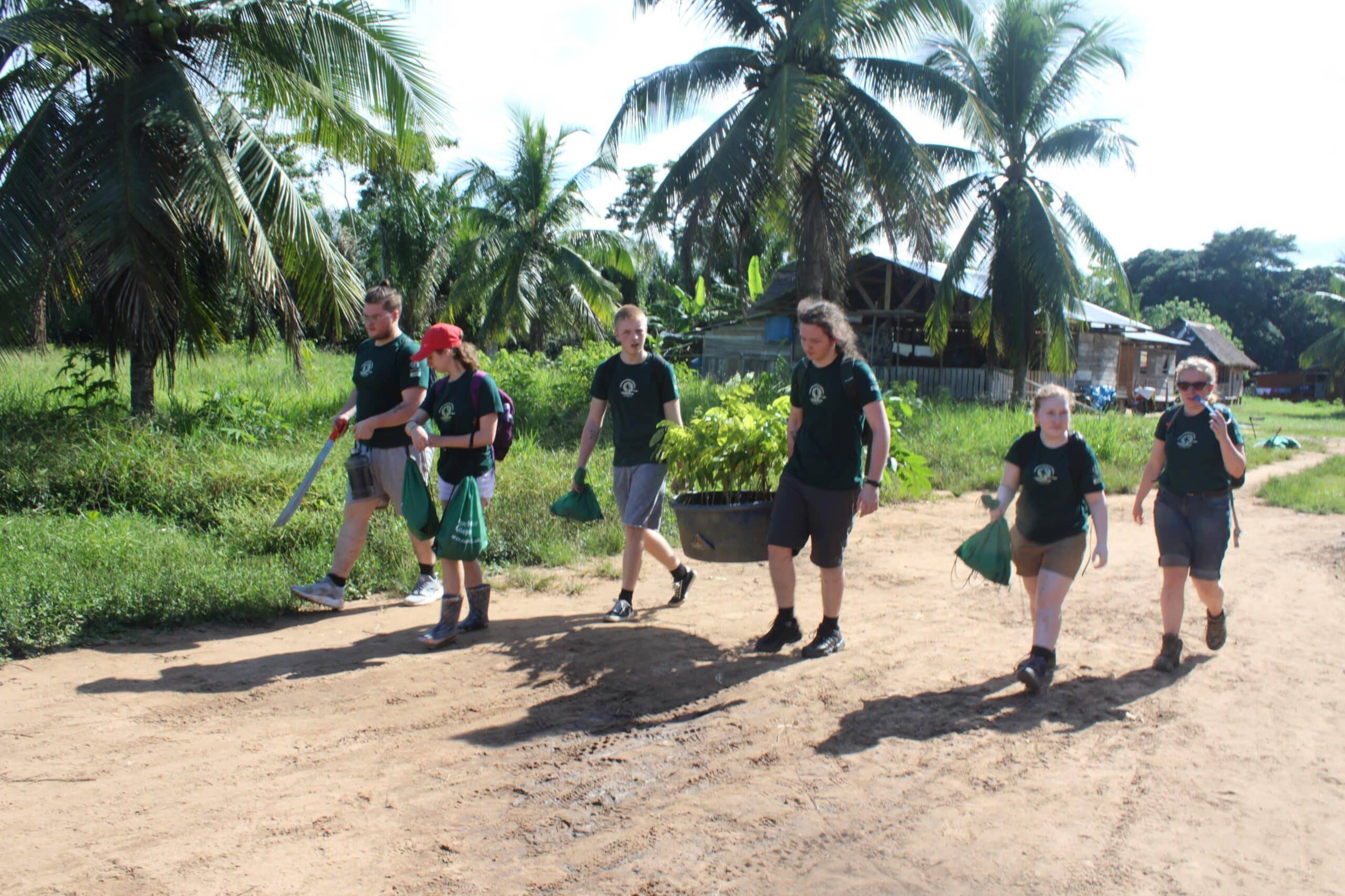 Projects Abroad volunteers take materials to the farm as part of the conservation work in the Amazon Rainforest in Peru.