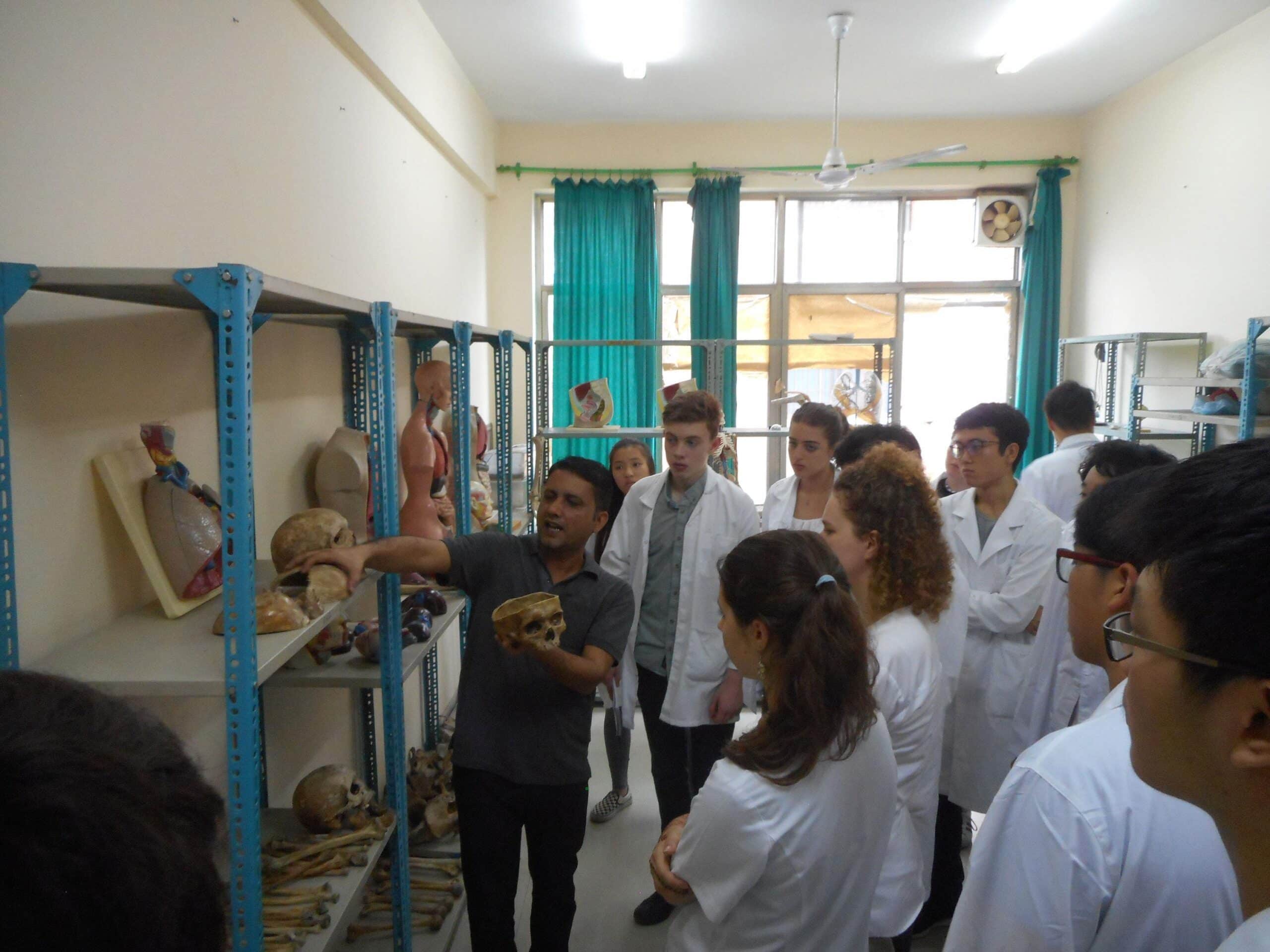 High School Special Medicine volunteers receive an anatomy lesson from a teacher at the Chitwan Medical College