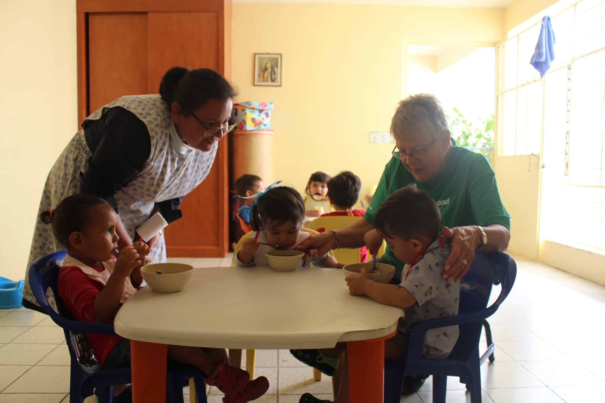 Senior volunteer taking care of children in a nursery during her Childcare project in Mexico.
