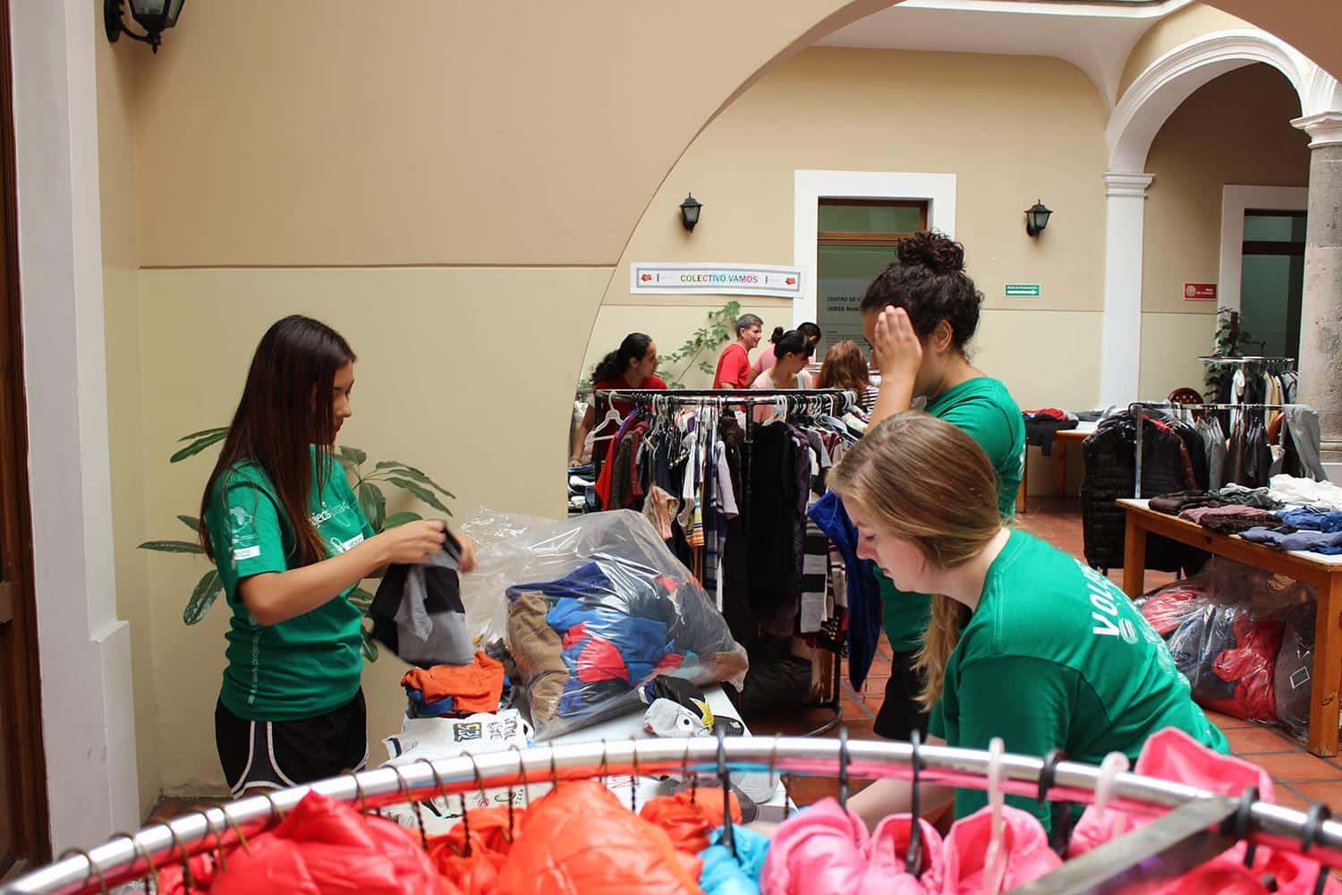 Volunteers sorting through clothing that will be given to the refugees passing through Mexico.