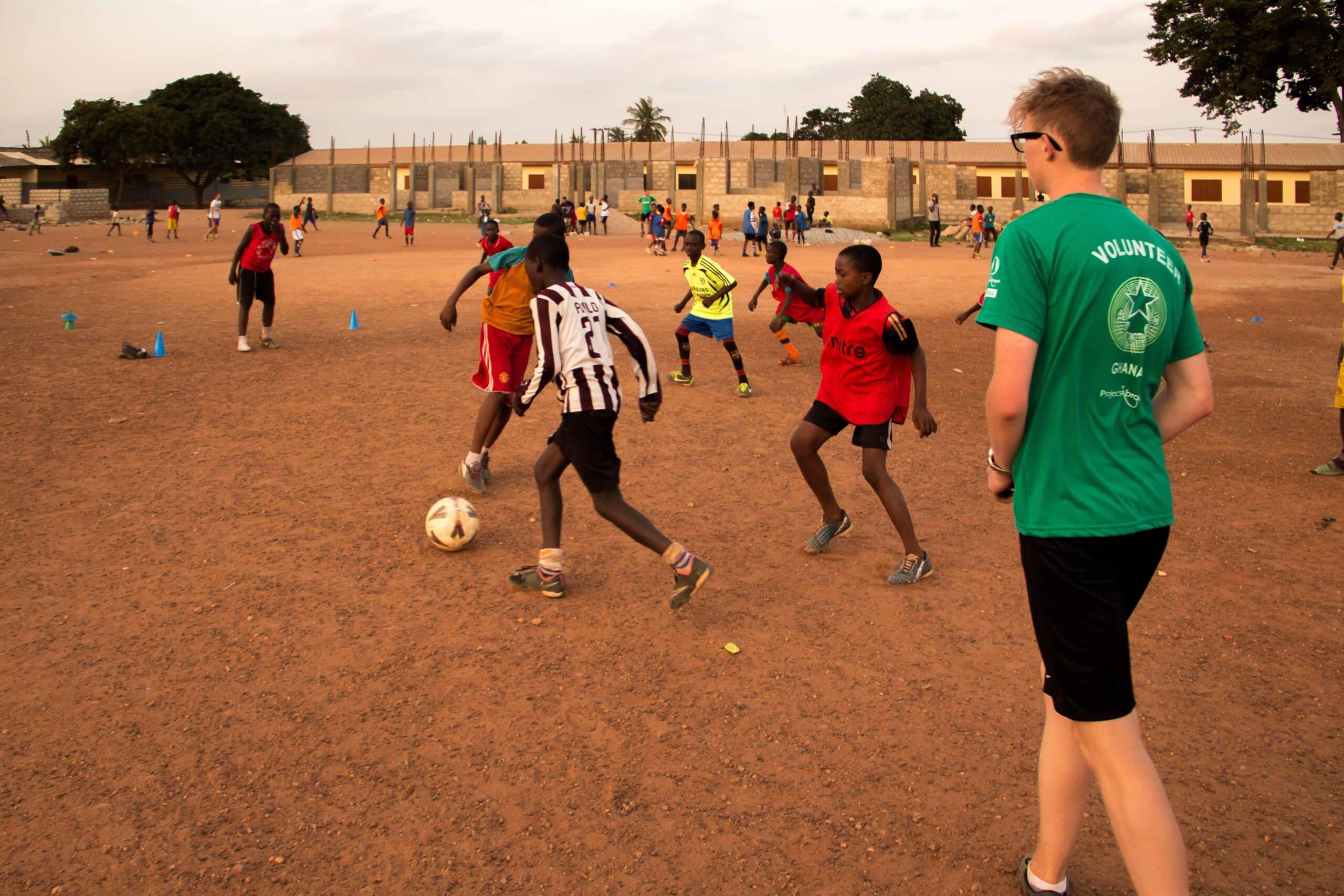 Projects Abroad High School Special volunteer referees a football match in Ghana during his Football Coaching project.