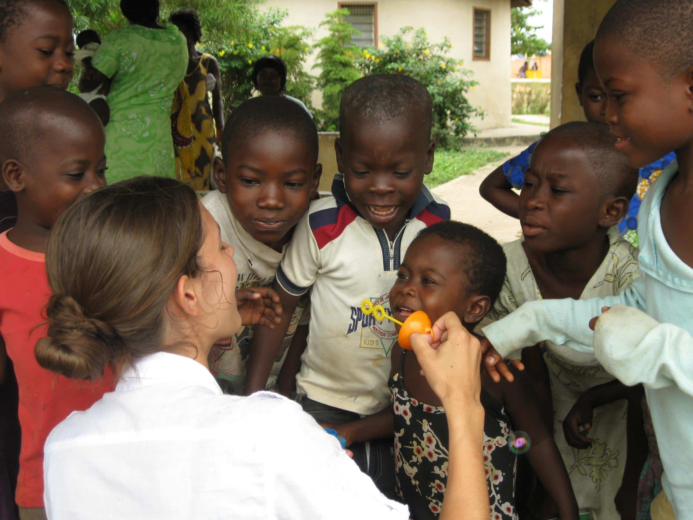 A social work volunteer plays with children and offers them support while doing her internship with Projects Abroad in Ghana.