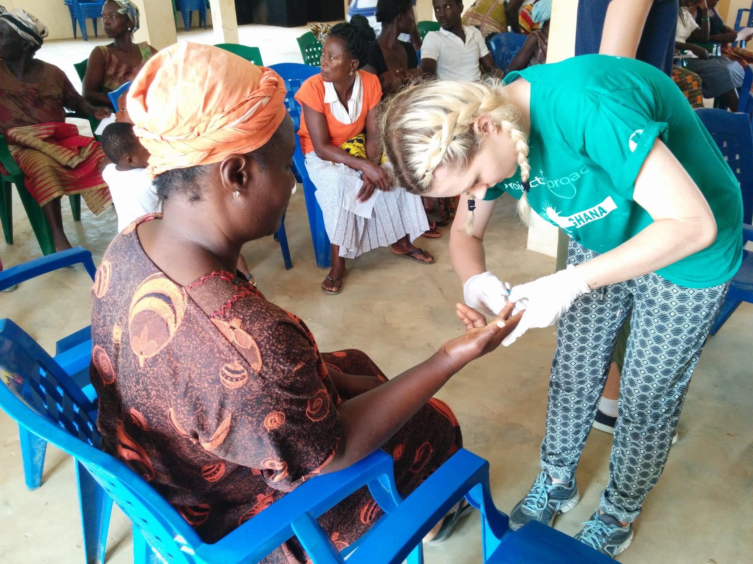 Projects Abroad nursing volunteer is taking a blood sample in Ghana during her internship.