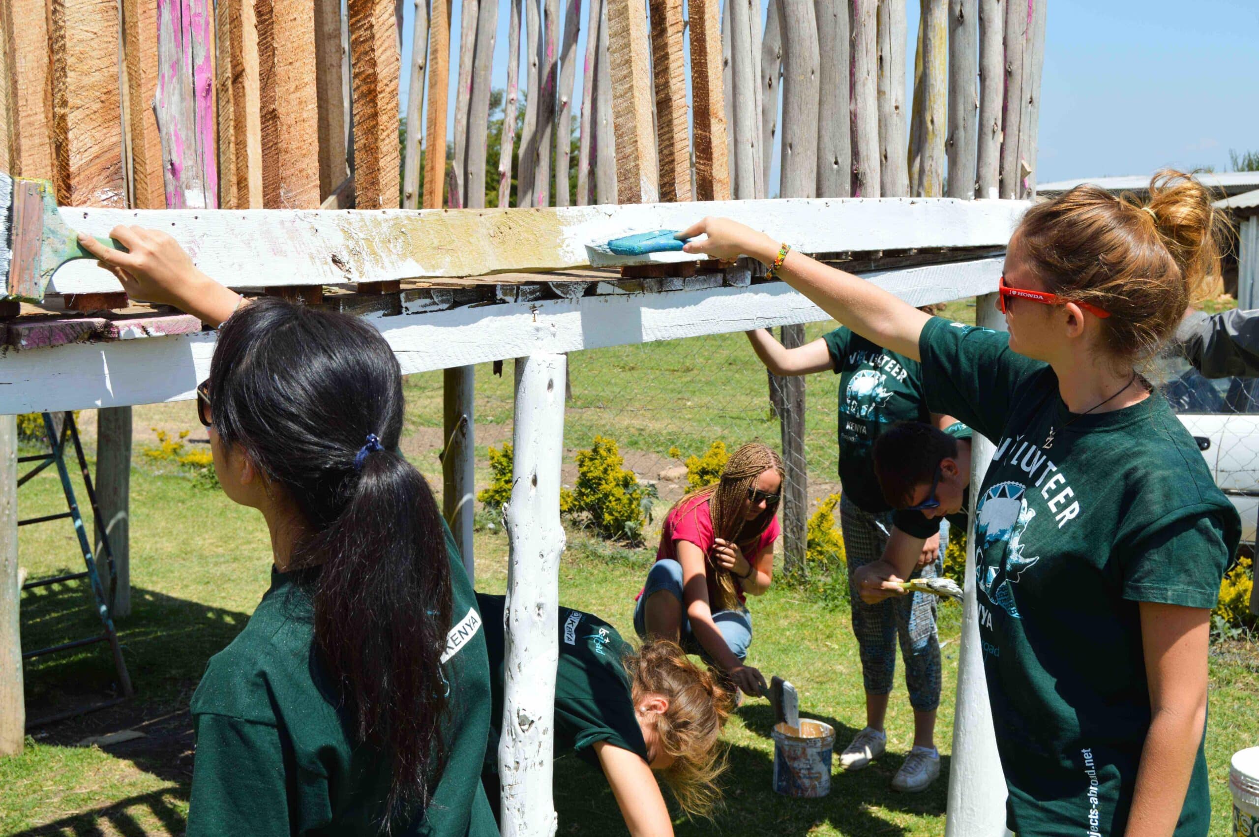 Teenage care volunteers take part in renovation work in a care center in Kenya during their internship with Projects Abroad.