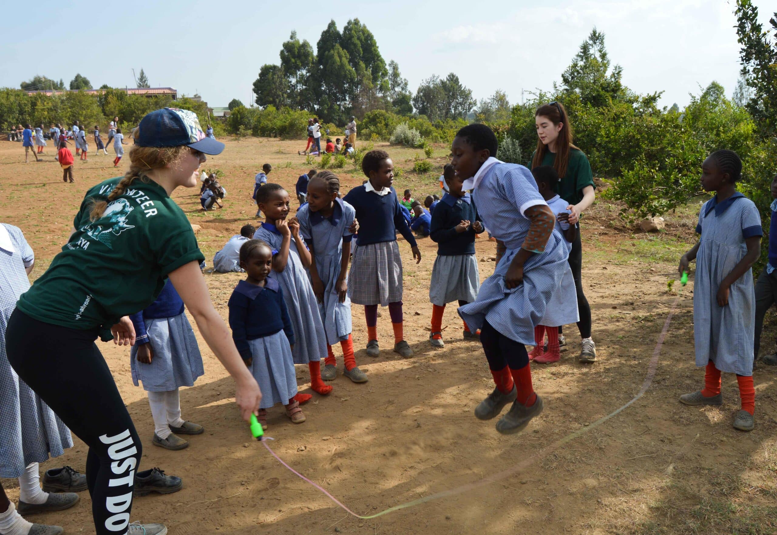 Teenage Projects Abroad care volunteers play with children in Kenya.