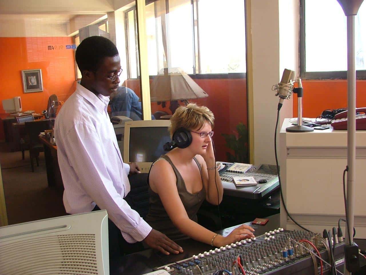 A local journalist and a Projects Abroad volunteer edit a story during her journalism internship in Ghana.