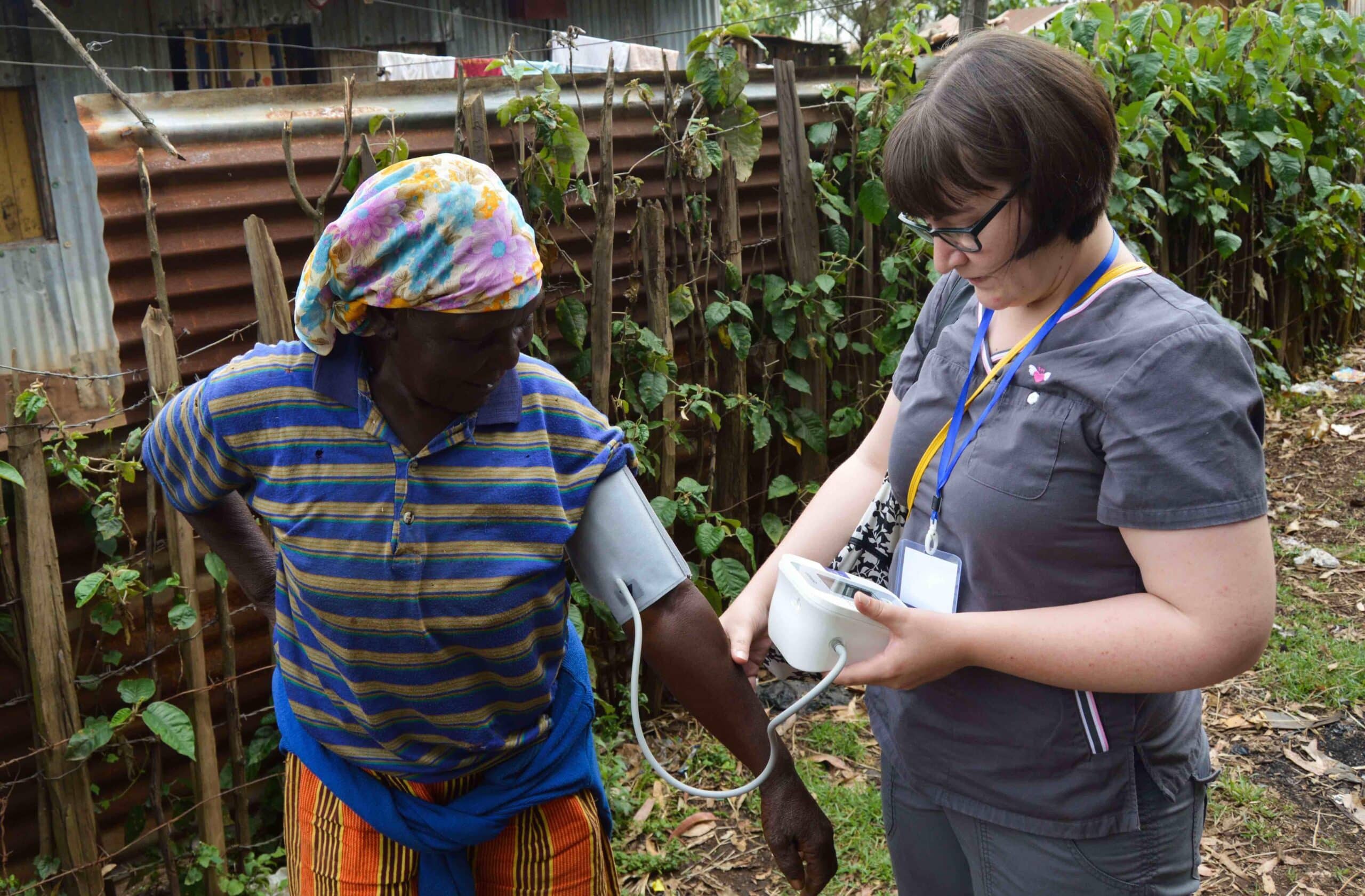 A Projects Abroad volunteer checks the blood pressure of a local woman in Kenya during her Nursing internship.