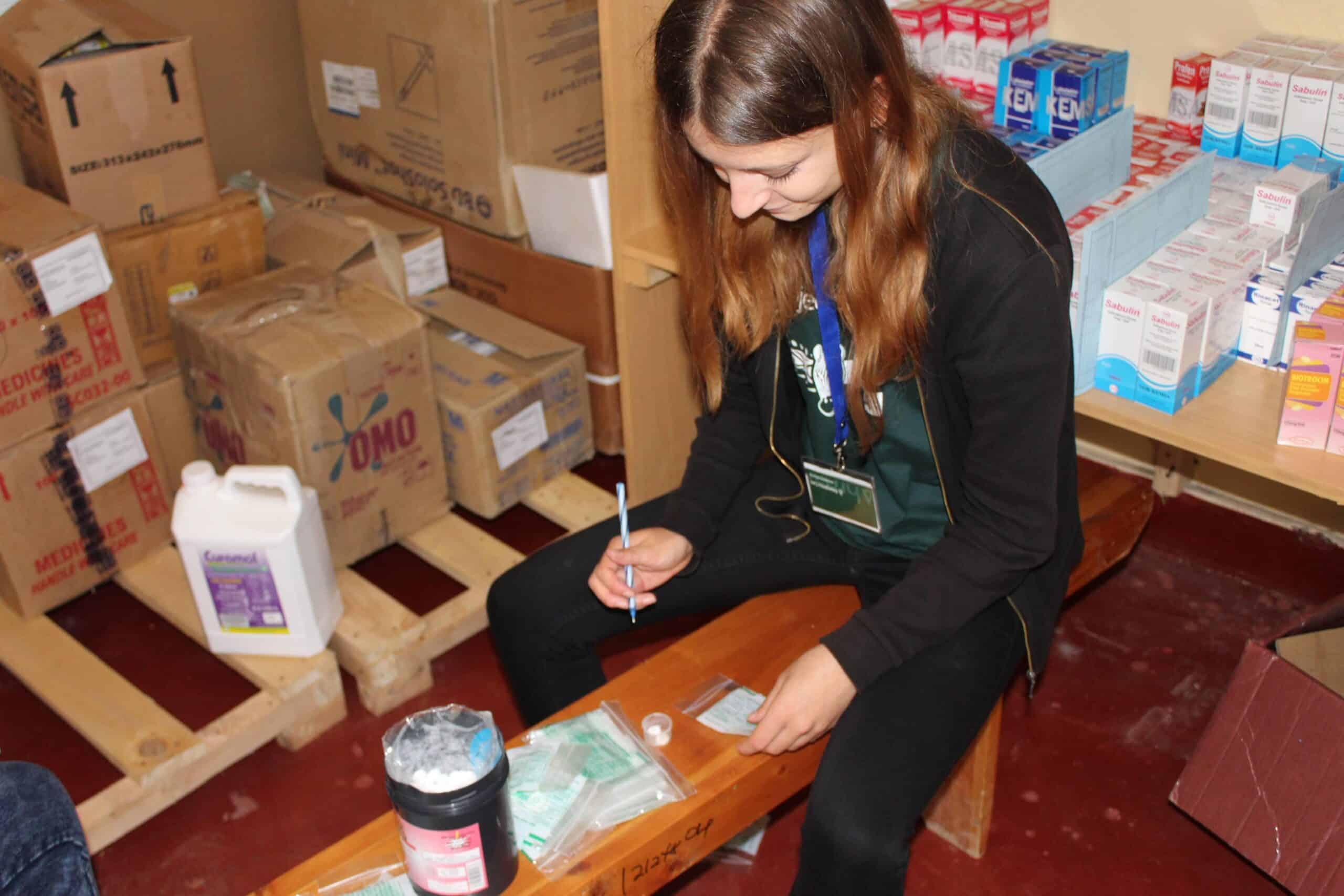 Projects Abroad volunteer classifies medicines in a hospital in Ghana during her pharmacy internship.