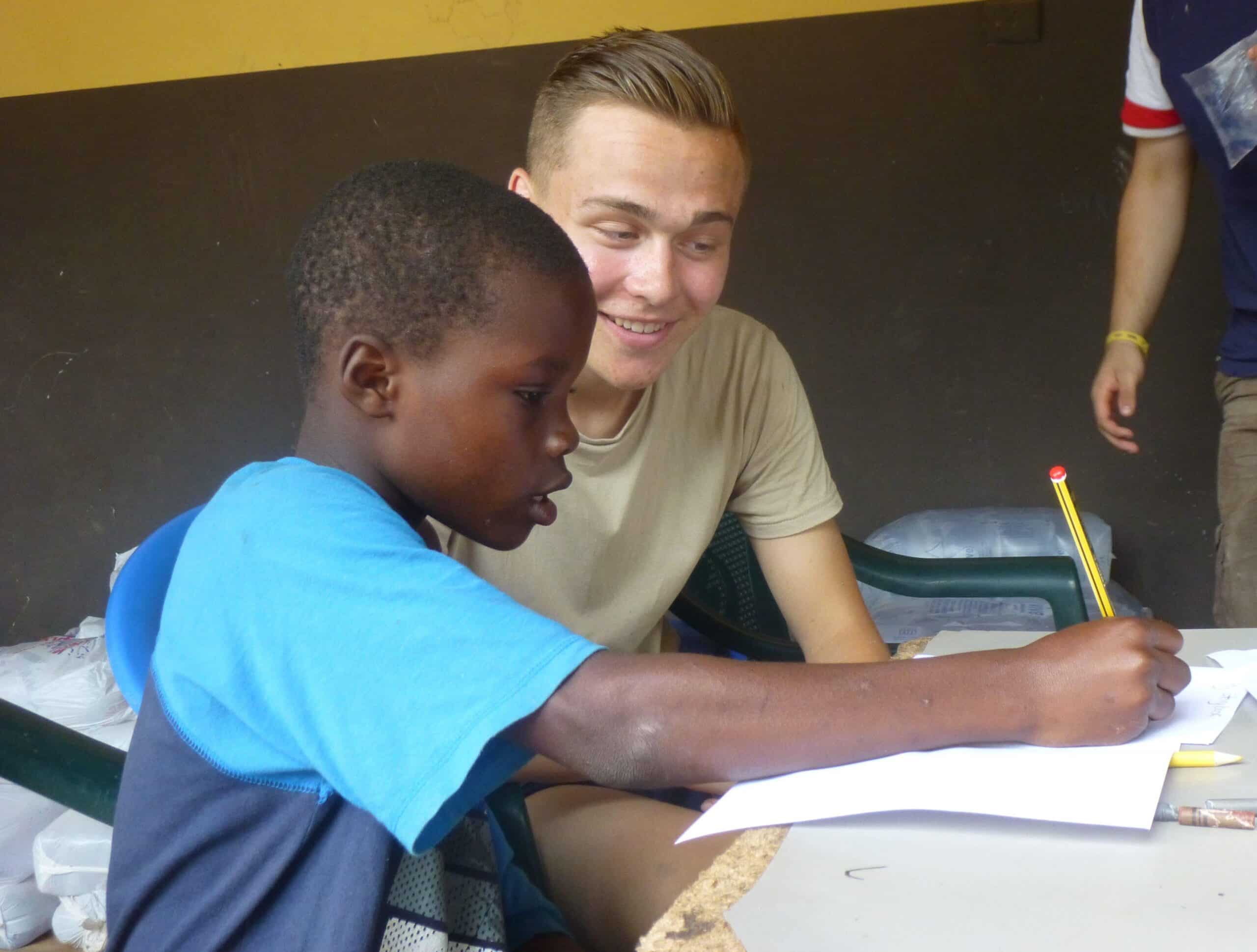 Projects Abroad volunteer helps a child to improve his speech skills through exercises in Ghana while doing his speech therapy internship.