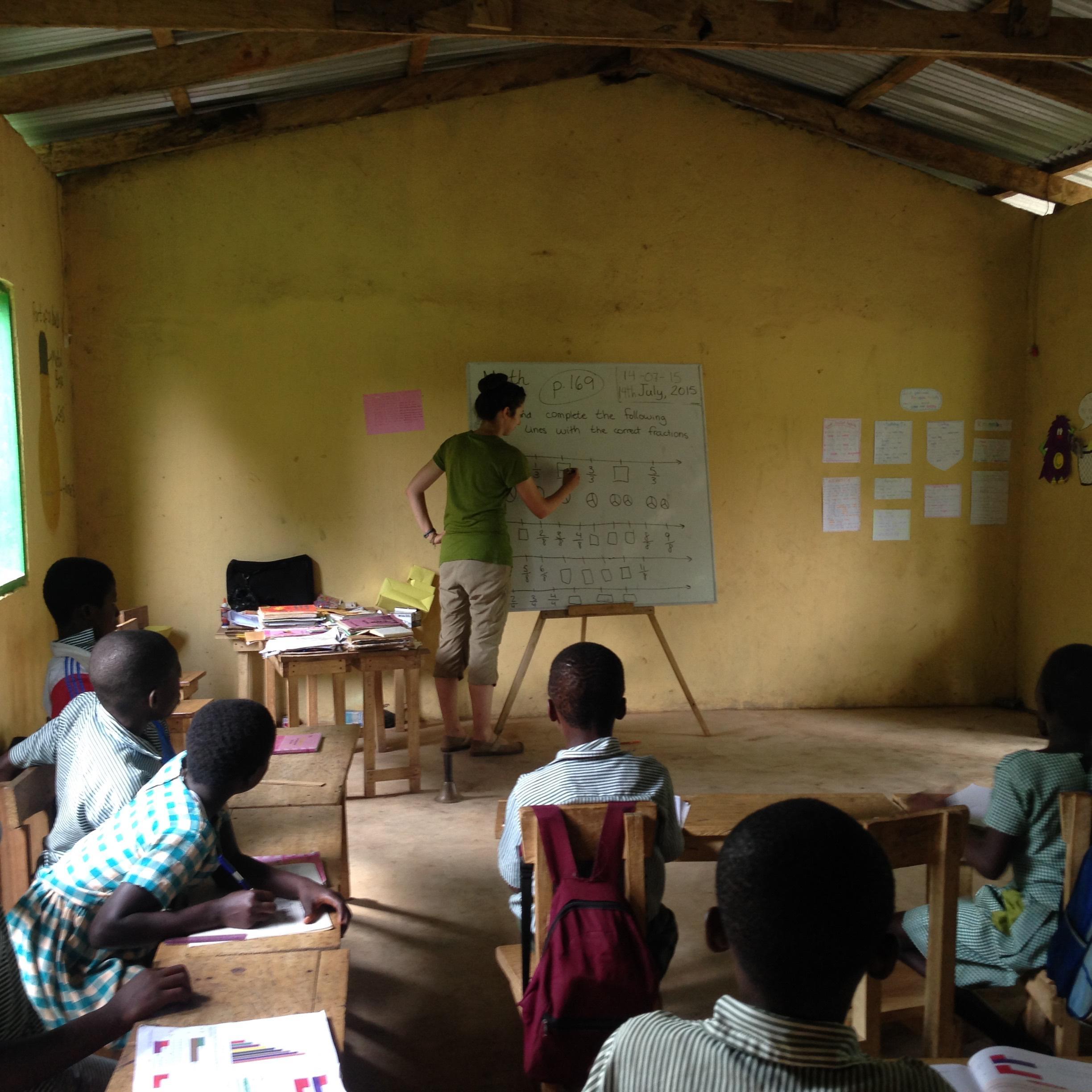 A volunteer doing a teaching English program with Projects Abroad prepares a lesson to local students in Ghana.
