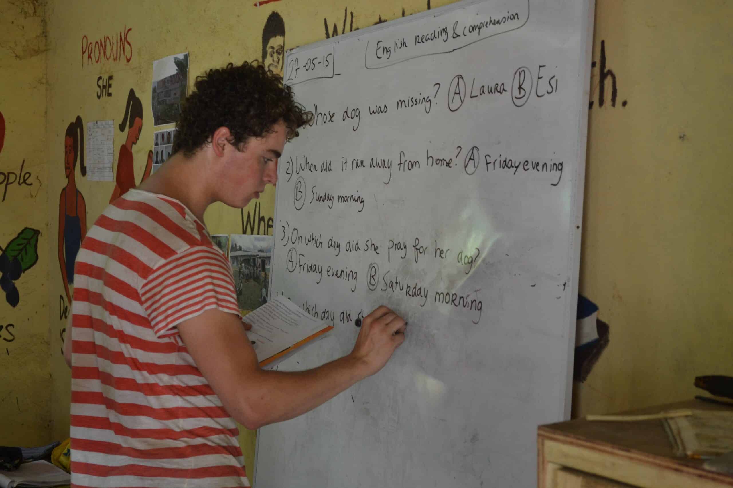 A Projects Abroad teaching volunteer prepares some English exercises for the class in Ghana.
