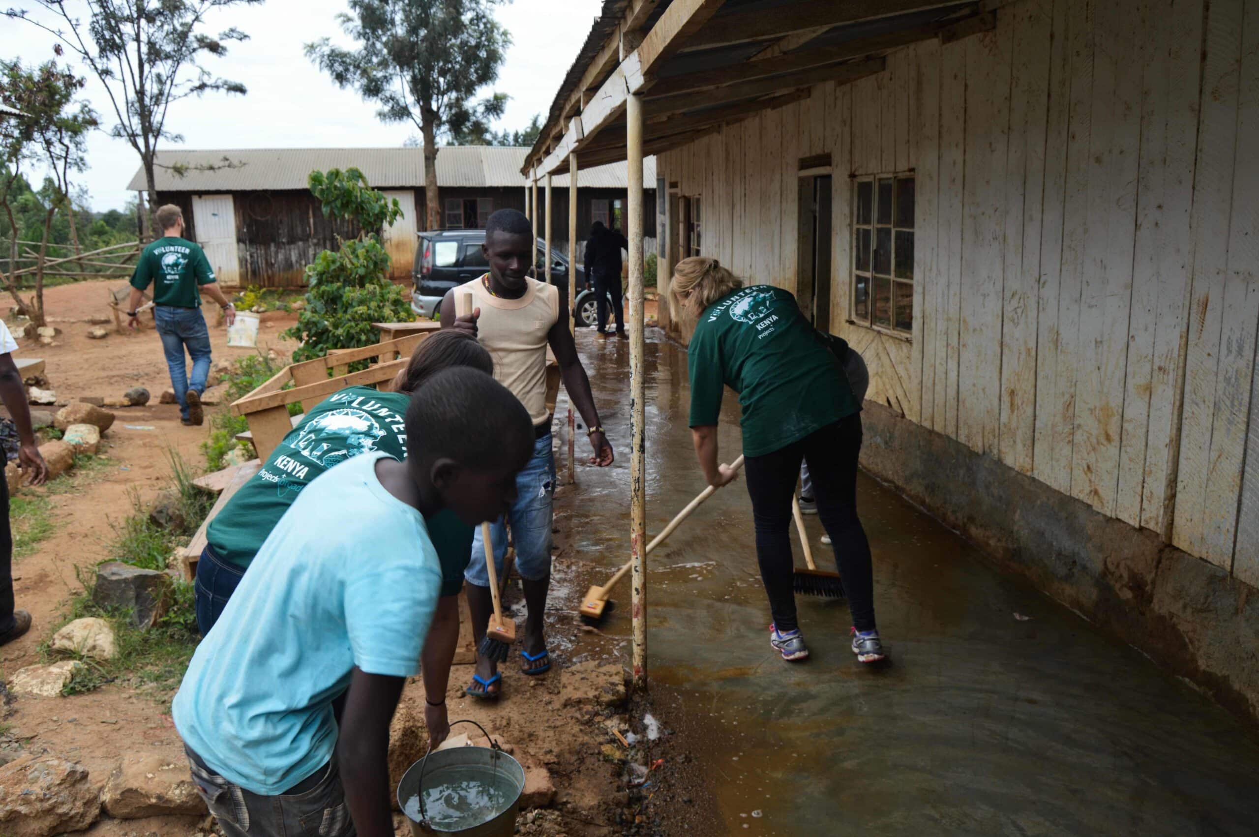 Some teaching volunteers help staff from a local school in Kenya to clean the facilities during their projects with Projects Abroad.
