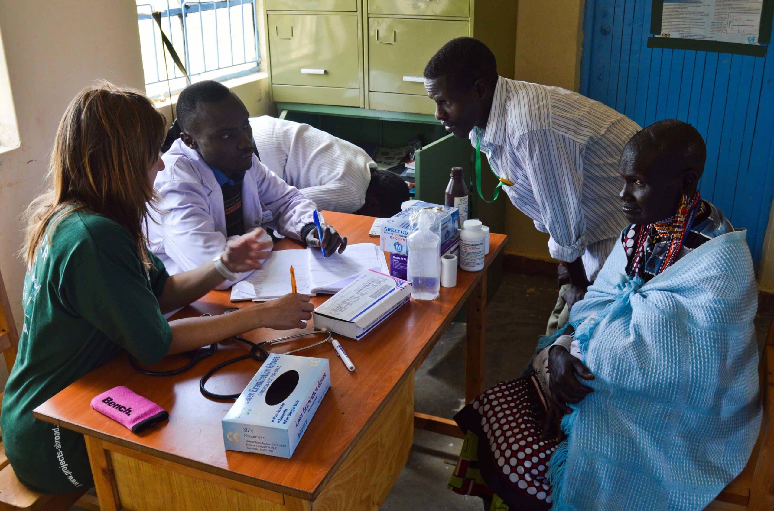 A Projects Abroad medical volunteer shadows a doctor during a medical consultation in Kenya.