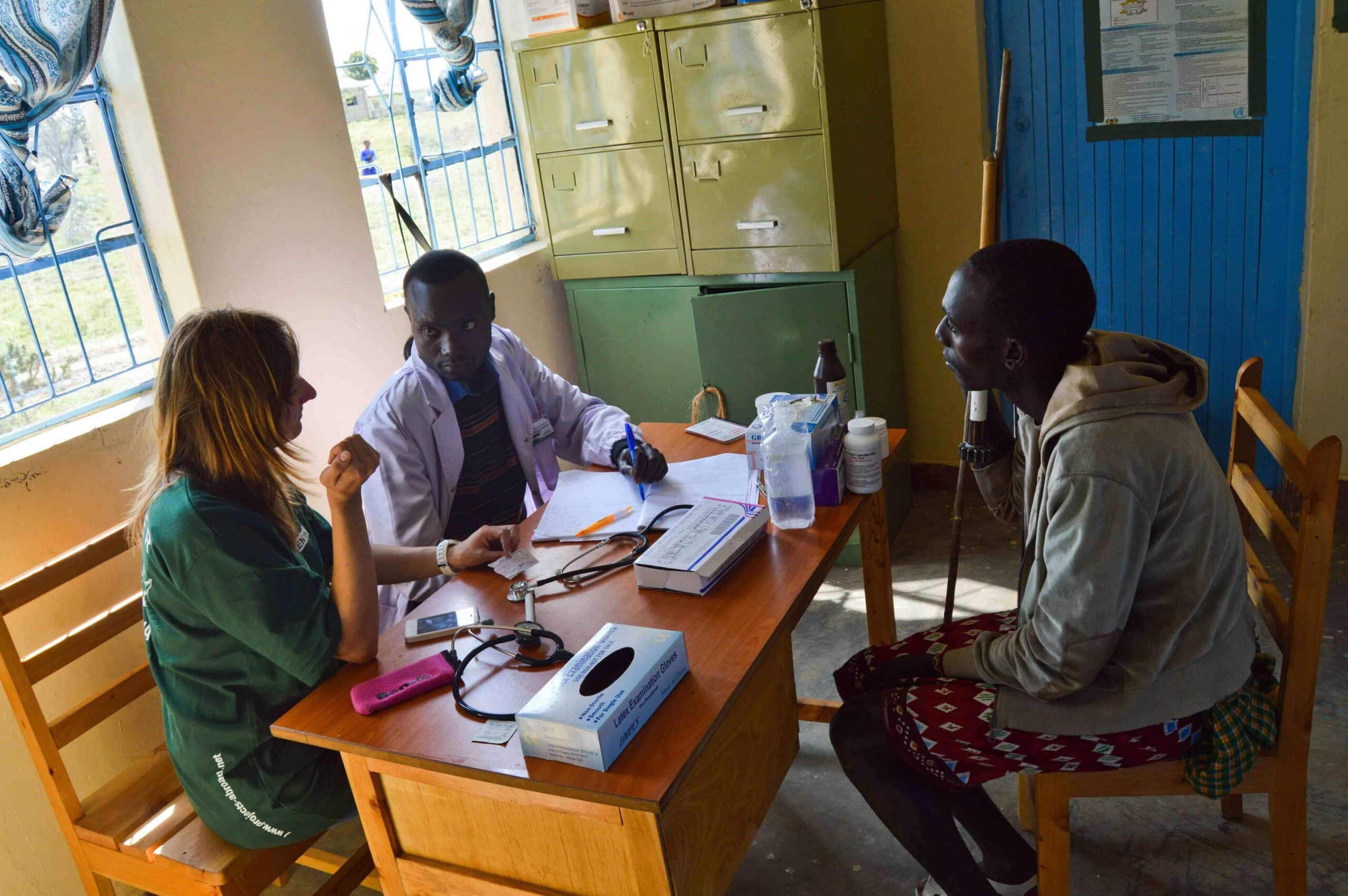 A Projects Abroad volunteer helps a local doctor in Kenya to assess a patient during her Occupational Therapy internship.