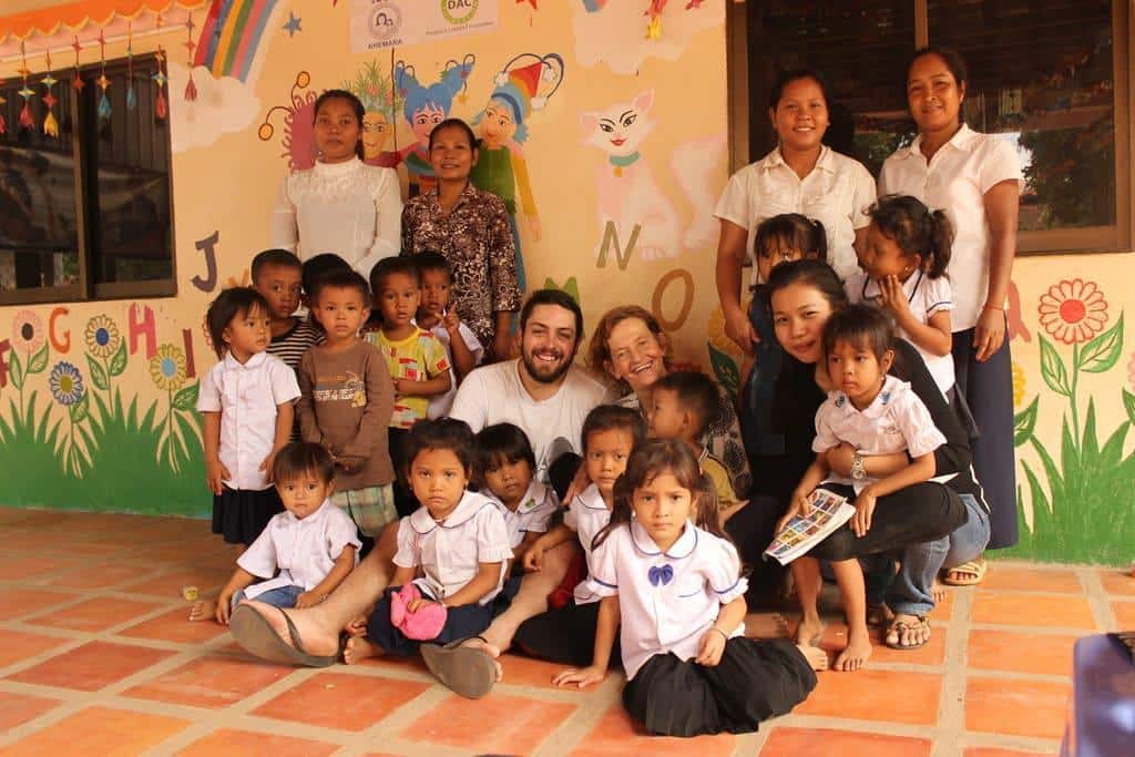 Interns with school children in Cambodia