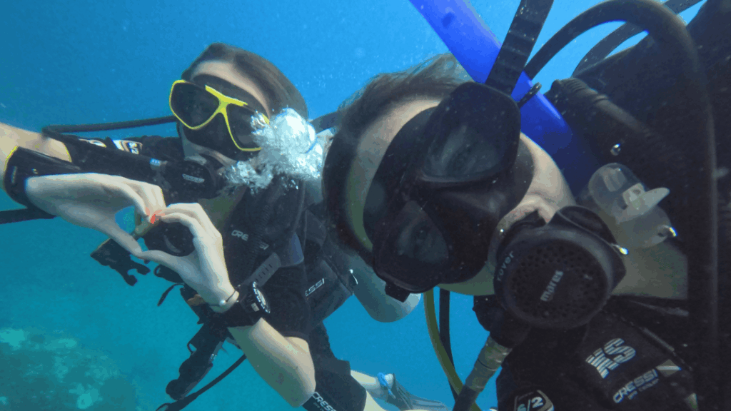 Volunteers posing underwater in Thailand